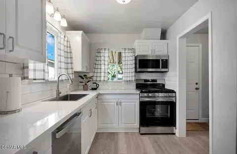 a kitchen with a sink stove and microwave