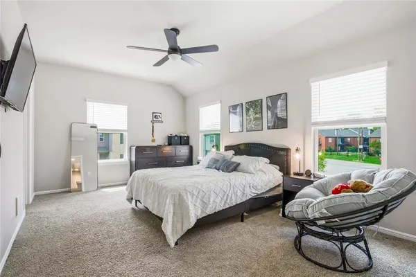 a bedroom with a bed and a chandelier