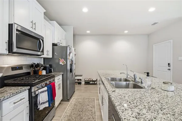 a kitchen with a sink stove and refrigerator