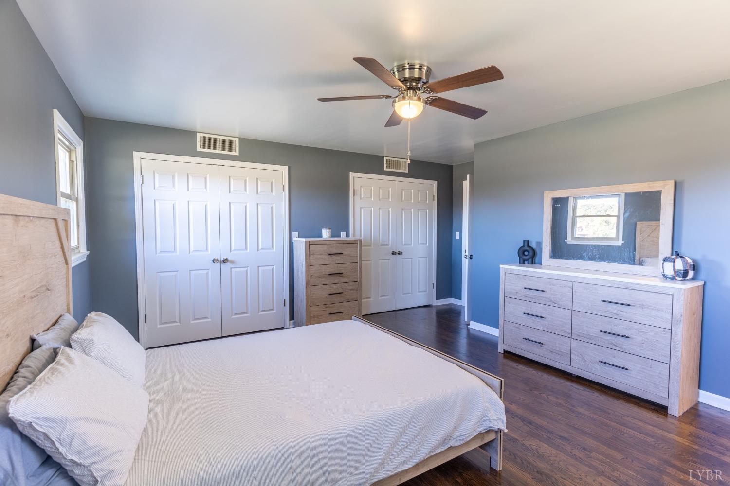 5461 Red House Road Rustburg, VA 24588 - Photo 12 of 47 a bedroom with a bed and a chandelier