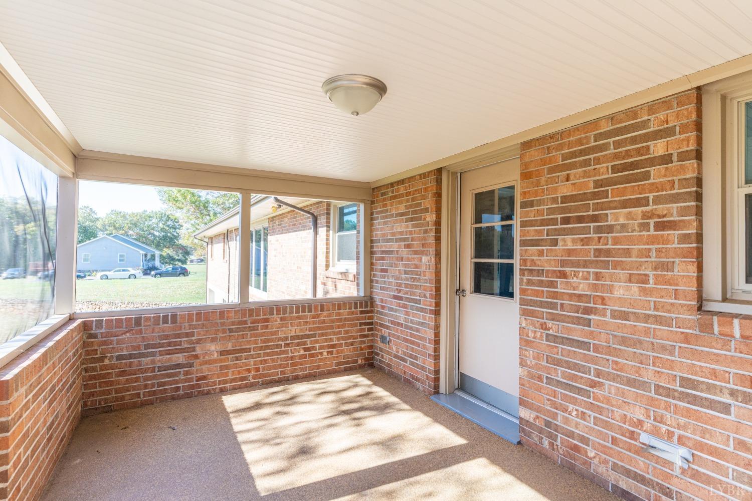 5461 Red House Road Rustburg, VA 24588 - Photo 21 of 47 a view of a porch with wooden floor and a yard