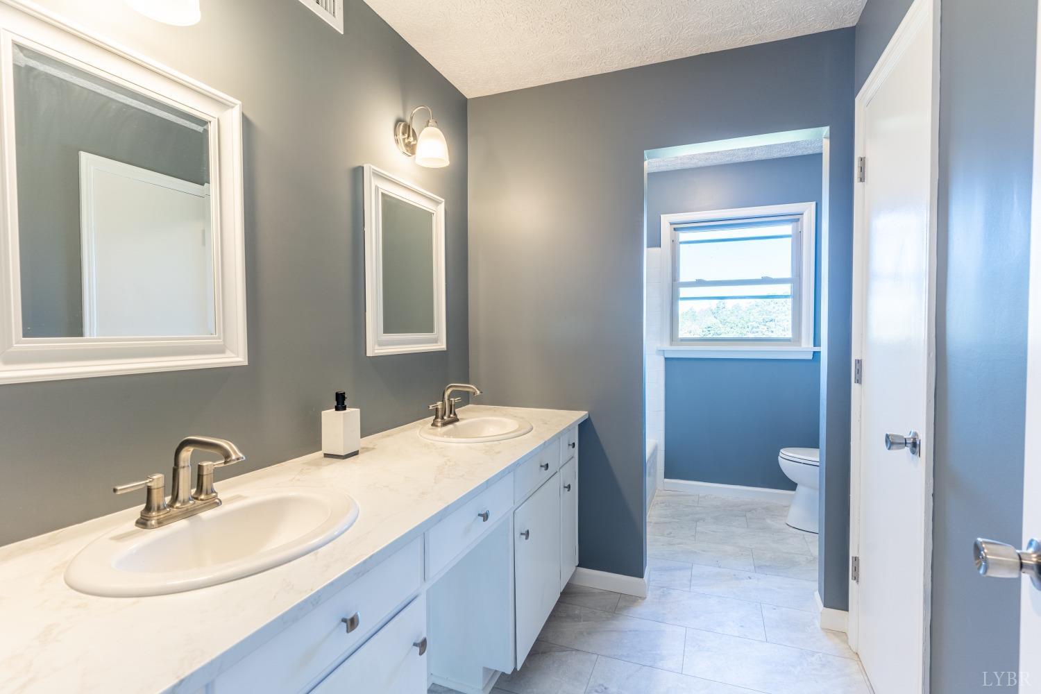 5461 Red House Road Rustburg, VA 24588 - Photo 7 of 47 a bathroom with a double vanity sink and a mirror