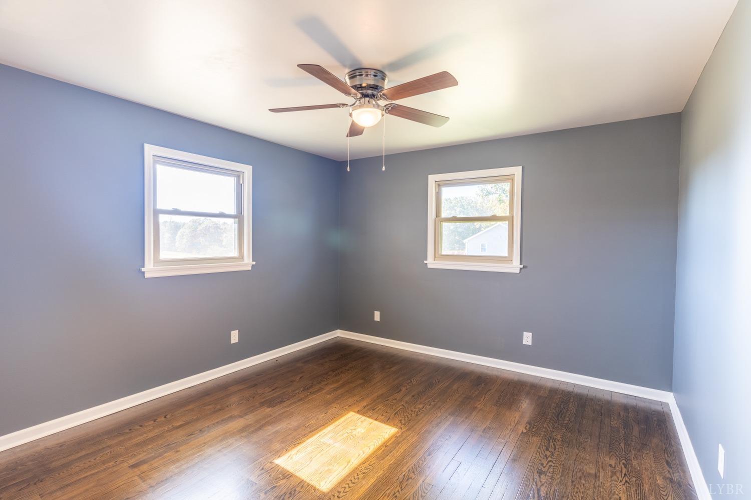 5461 Red House Road Rustburg, VA 24588 - Photo 10 of 47 a view of empty room with wooden floor and fan