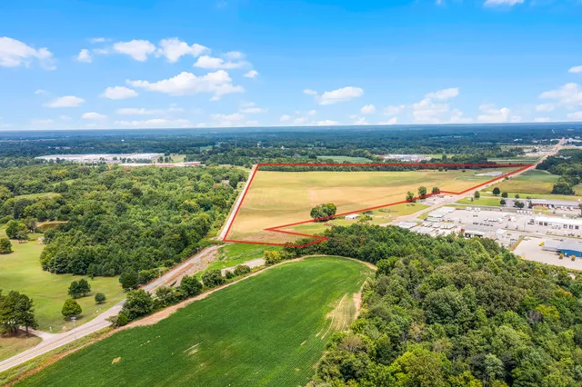 an aerial view of ocean and residential houses with outdoor space