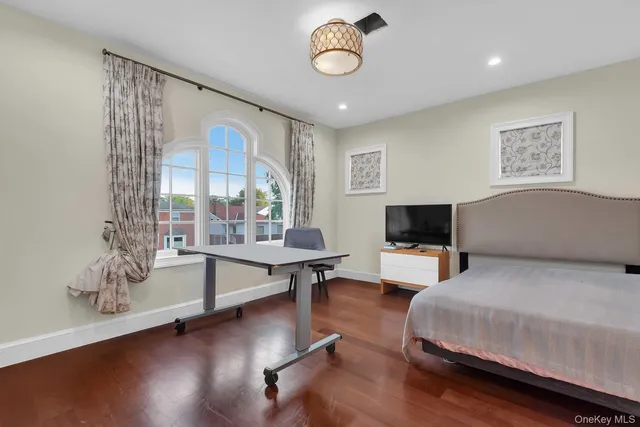 a living room with furniture a flat screen tv and wooden floor