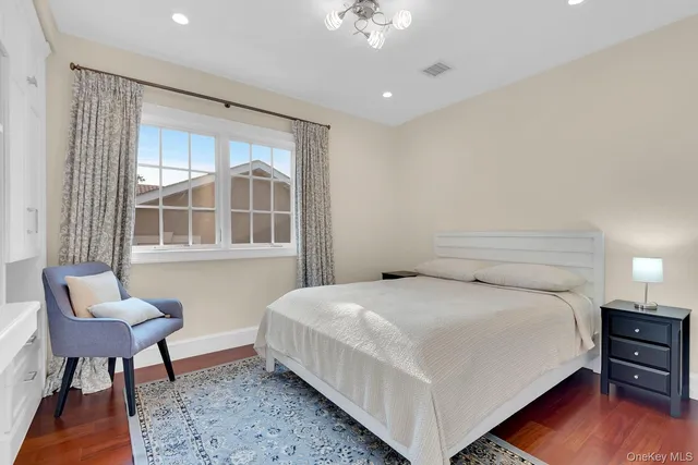 a bedroom with a bed and a chair