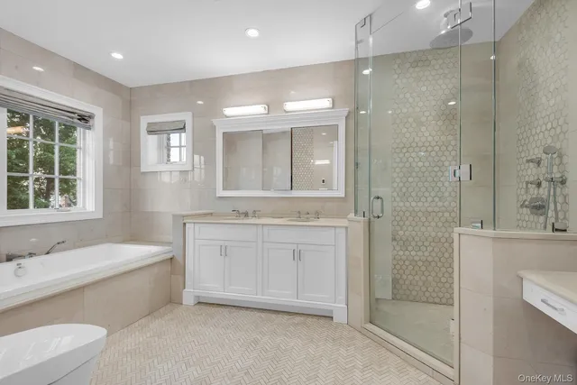 a bathroom with a granite countertop sink a toilet and shower