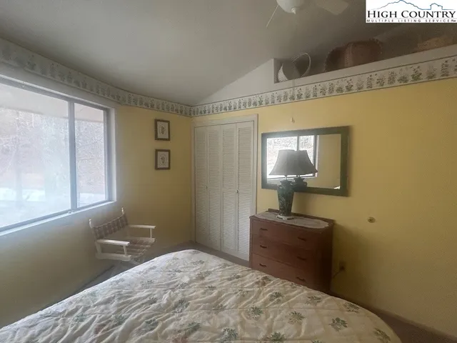 a bedroom with two beds and a window