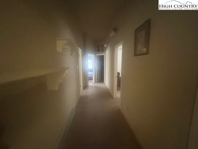 a view of a street sign under a large tree