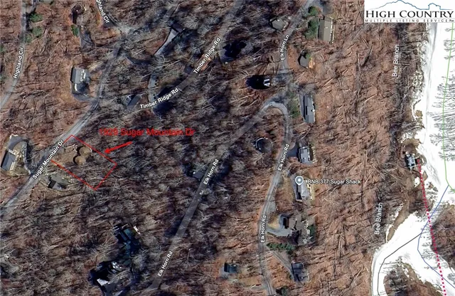 a view of a house with wooden fence