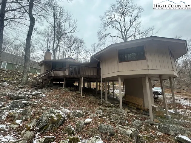 a kitchen with a table chairs refrigerator and window