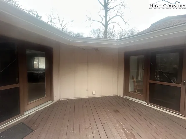 a living room with furniture a flat screen tv and windows