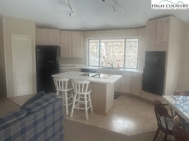 a living room with a fireplace and a flat screen tv