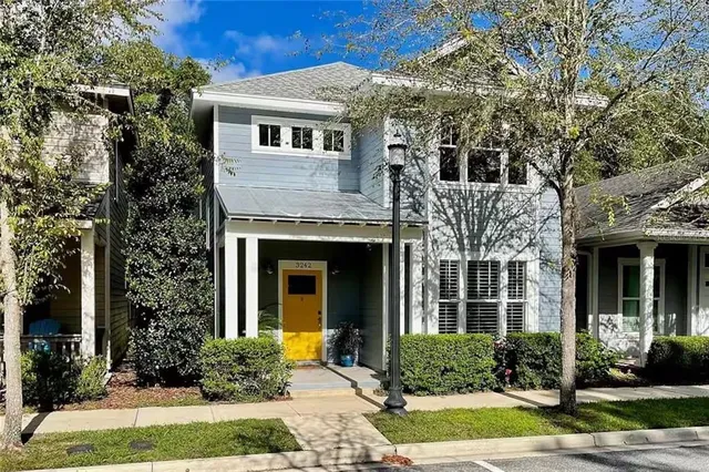a front view of a house with garden and plants