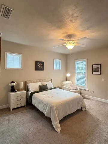 a bedroom with double bed and a lamp