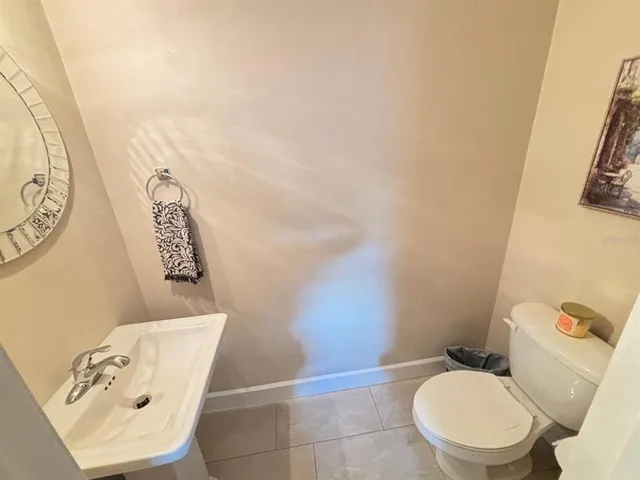 a white toilet sitting next to a bathroom sink