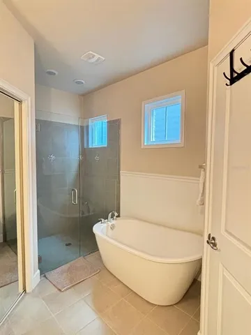 a bathroom with a tub and shower