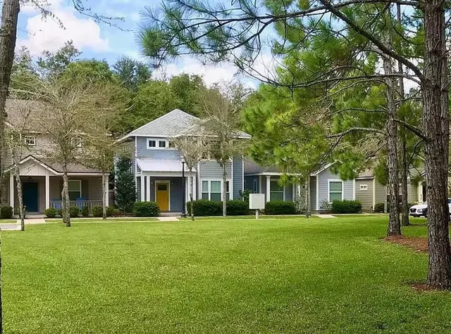 a front view of a building with a garden