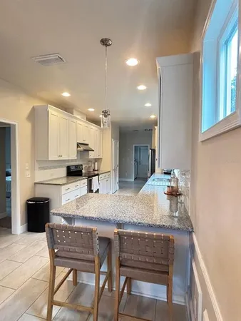 a kitchen with a table and chairs in it