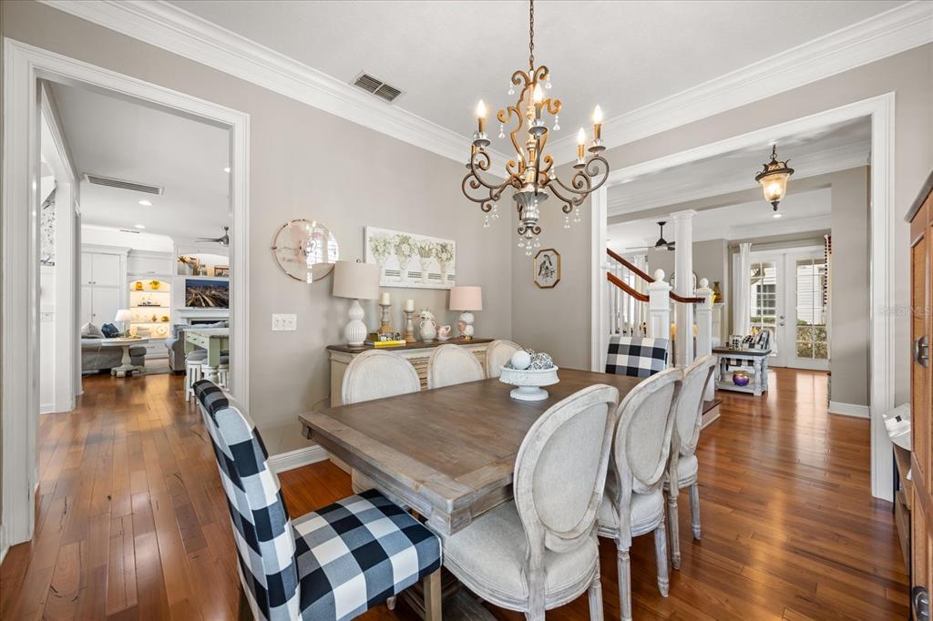 815 Spring Park Loop Celebration, FL 34747 - Photo 18 of 51 a view of a dining room with furniture wooden floor and chandelier