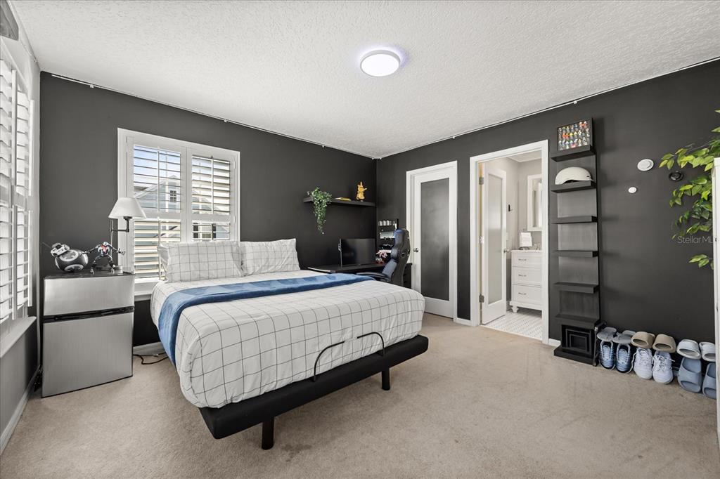 815 Spring Park Loop Celebration, FL 34747 - Photo 19 of 51 a bedroom with a bed and a dresser