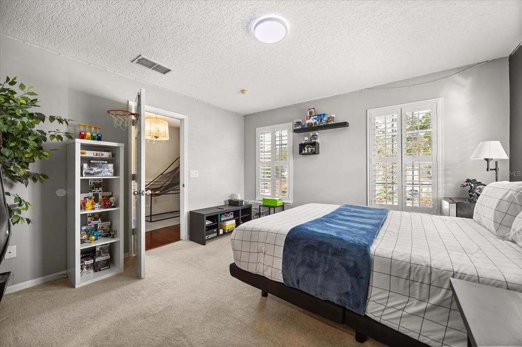 815 Spring Park Loop Celebration, FL 34747 - Photo 20 of 51 a bedroom with bed and a book shelf