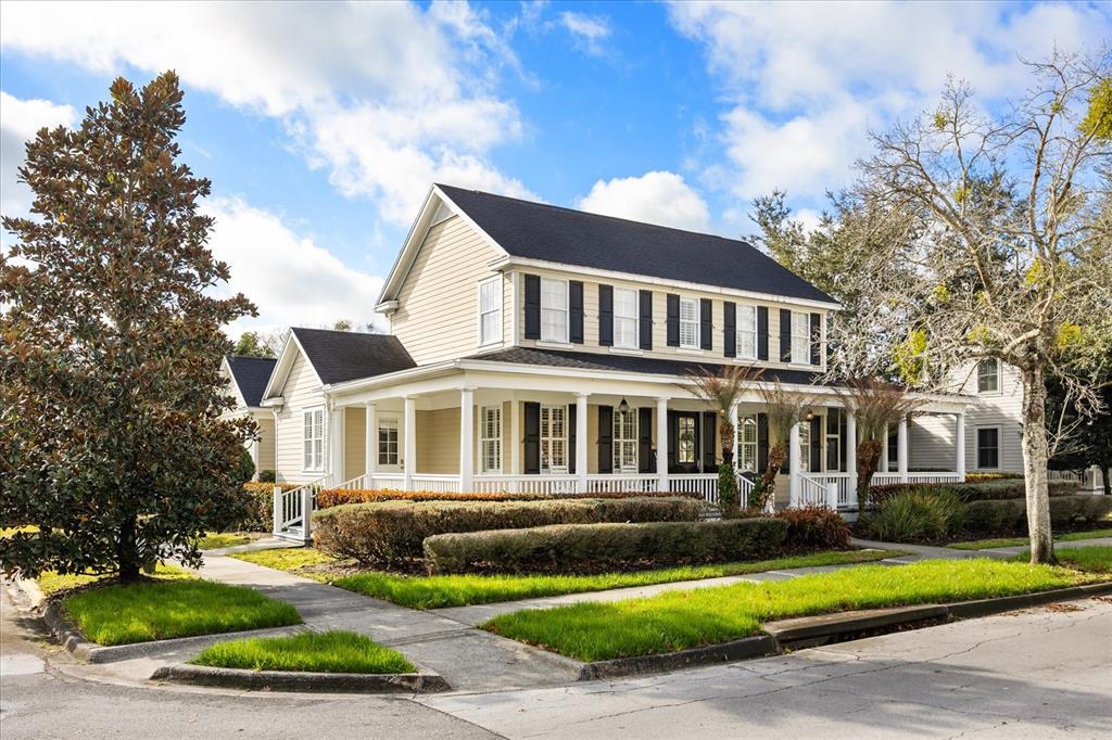 815 Spring Park Loop Celebration, FL 34747 - Photo 2 of 51 a front view of a house with a yard table and chairs