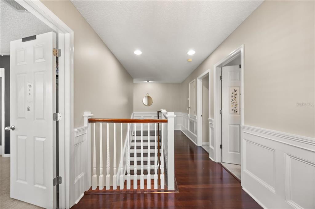 815 Spring Park Loop Celebration, FL 34747 - Photo 23 of 51 a view of a hallway with wooden floor and staircase