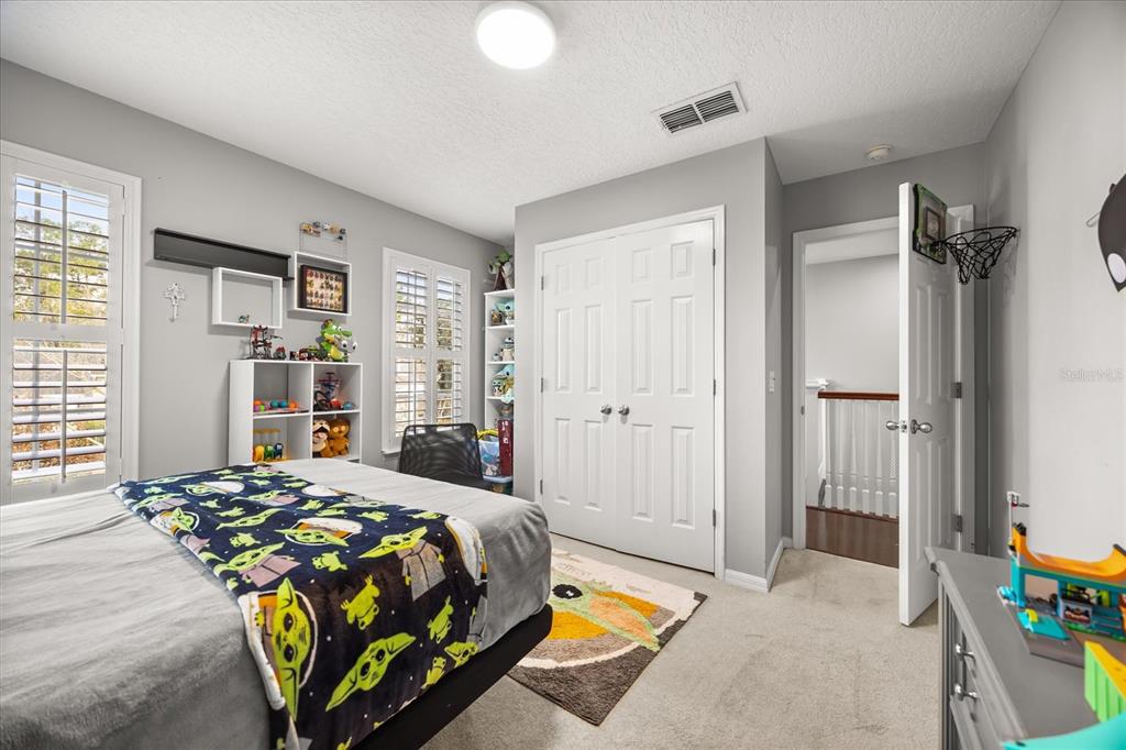 815 Spring Park Loop Celebration, FL 34747 - Photo 25 of 51 a bedroom with a bed and a window