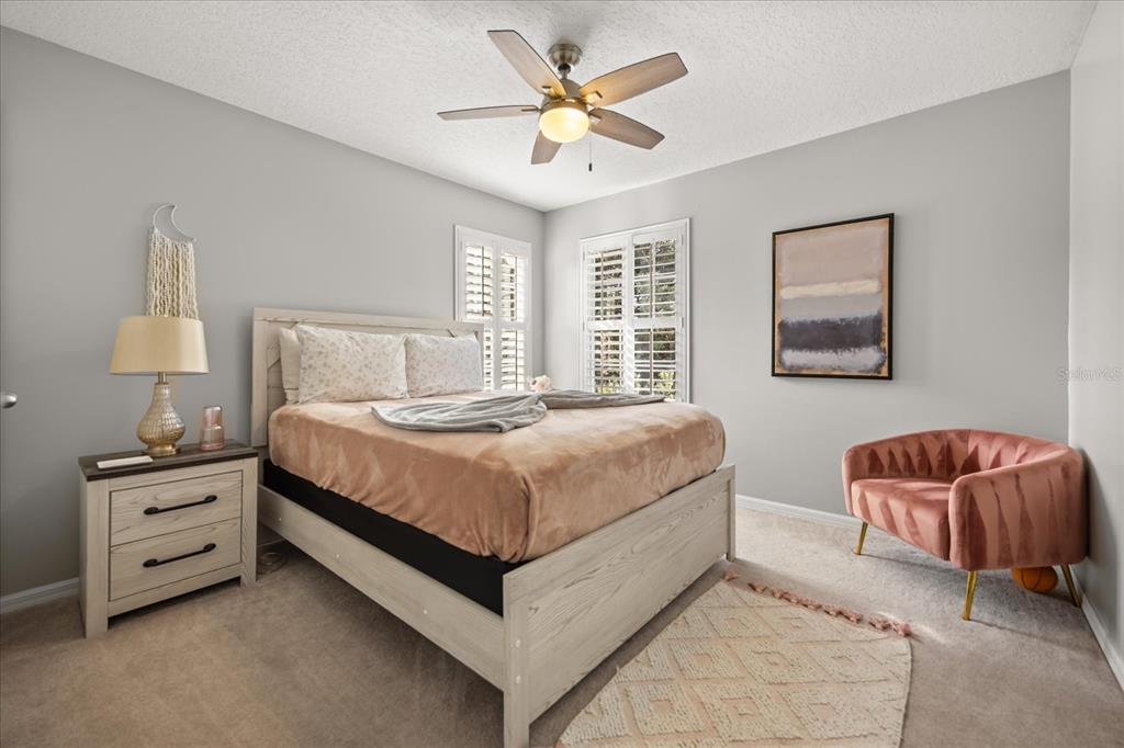 815 Spring Park Loop Celebration, FL 34747 - Photo 26 of 51 a bedroom with a bed and a couch