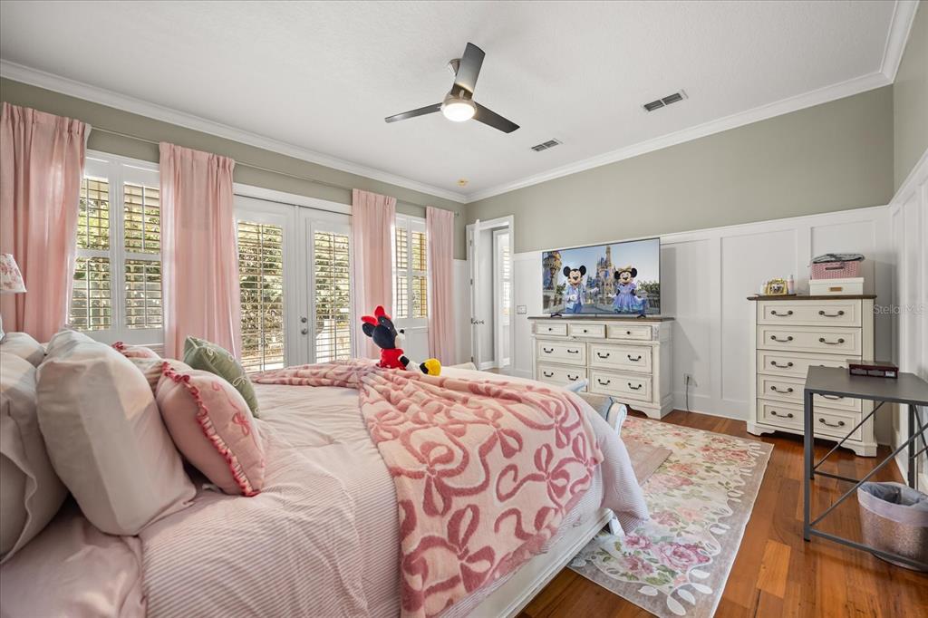 815 Spring Park Loop Celebration, FL 34747 - Photo 31 of 51 a bedroom with a bed and wooden floor