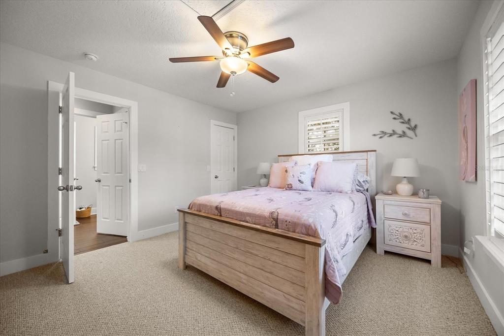 815 Spring Park Loop Celebration, FL 34747 - Photo 36 of 51 a spacious bedroom with a bed and a ceiling fan