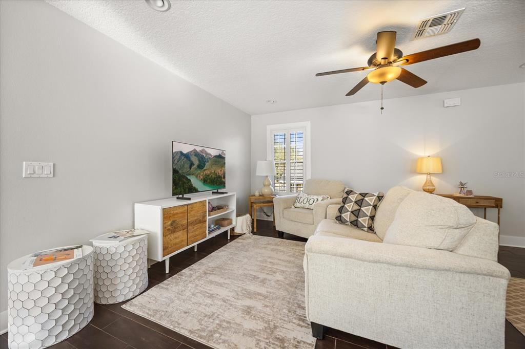 815 Spring Park Loop Celebration, FL 34747 - Photo 43 of 51 a living room with furniture and a flat screen tv
