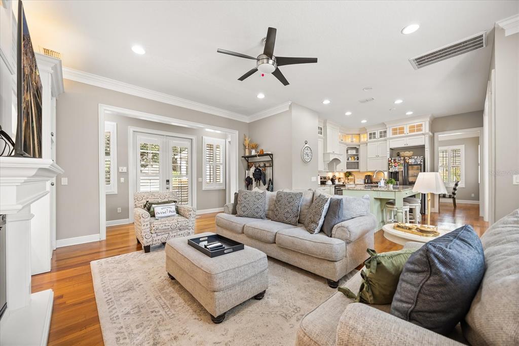 815 Spring Park Loop Celebration, FL 34747 - Photo 7 of 51 a living room with furniture kitchen view and a fireplace