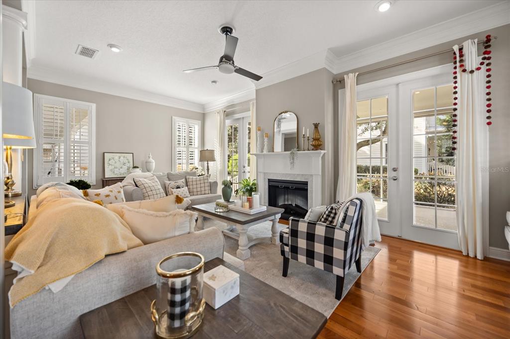 815 Spring Park Loop Celebration, FL 34747 - Photo 10 of 51 a living room with furniture a fireplace and wooden floor