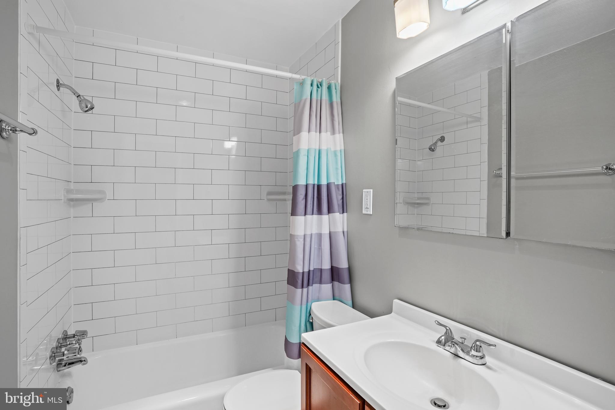 1900 Lyttonsville Road, Unit 612 Silver Spring, MD 20910 - Photo 12 of 23 a bathroom with a sink and shower