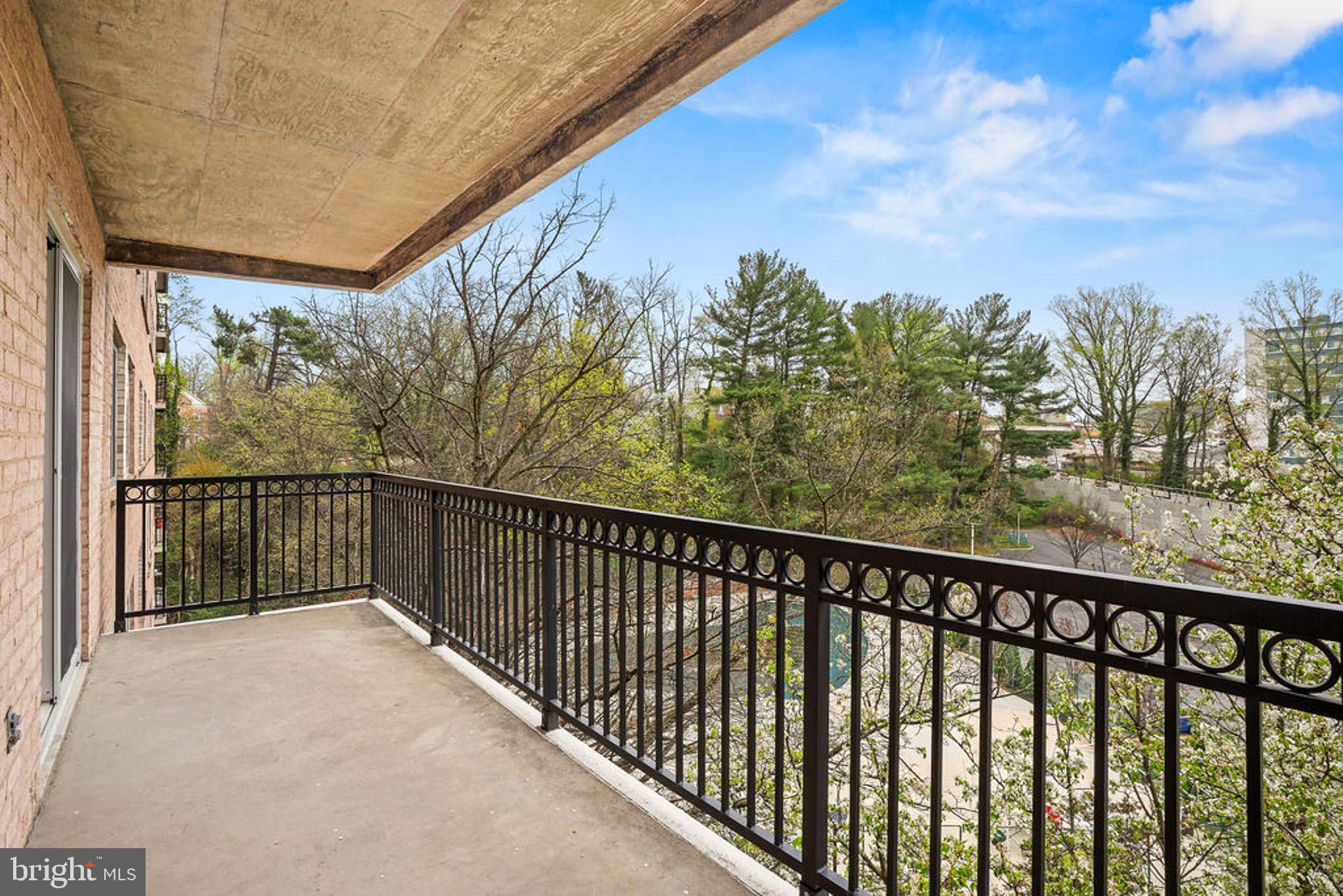 1900 Lyttonsville Road, Unit 612 Silver Spring, MD 20910 - Photo 16 of 23 a balcony with trees in front of it