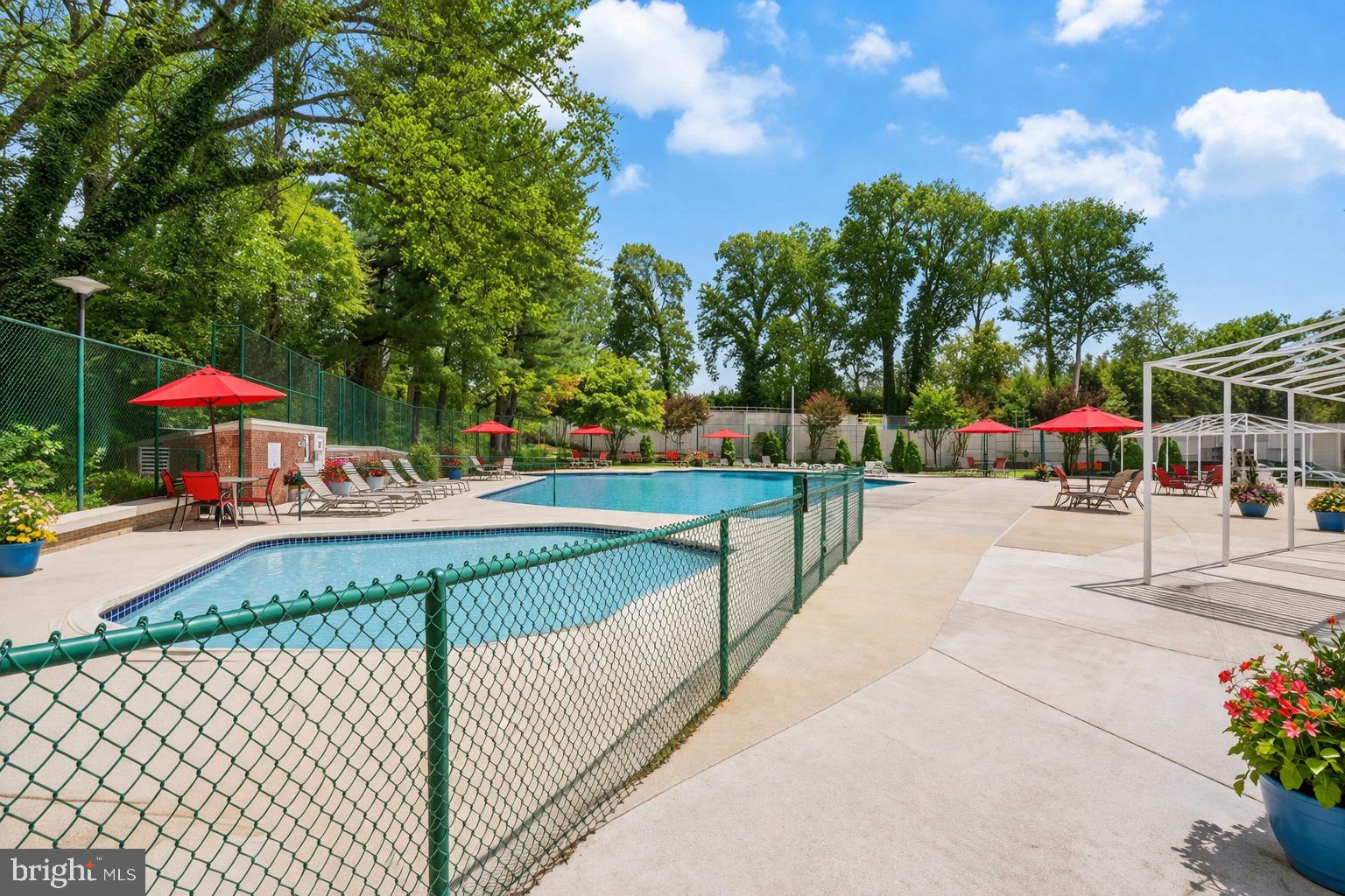 1900 Lyttonsville Road, Unit 612 Silver Spring, MD 20910 - Photo 20 of 23 a view of a swimming pool with a patio and a garden