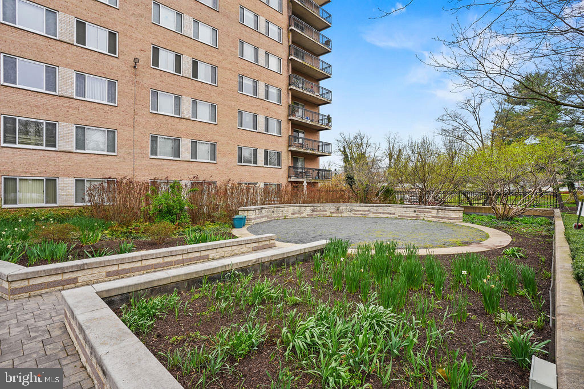 1900 Lyttonsville Road, Unit 612 Silver Spring, MD 20910 - Photo 21 of 23 a view of a building with garden and sitting area