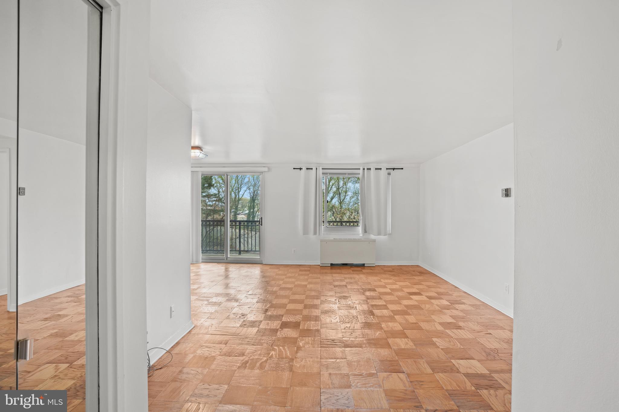 1900 Lyttonsville Road, Unit 612 Silver Spring, MD 20910 - Photo 5 of 23 a view of an empty room with a window