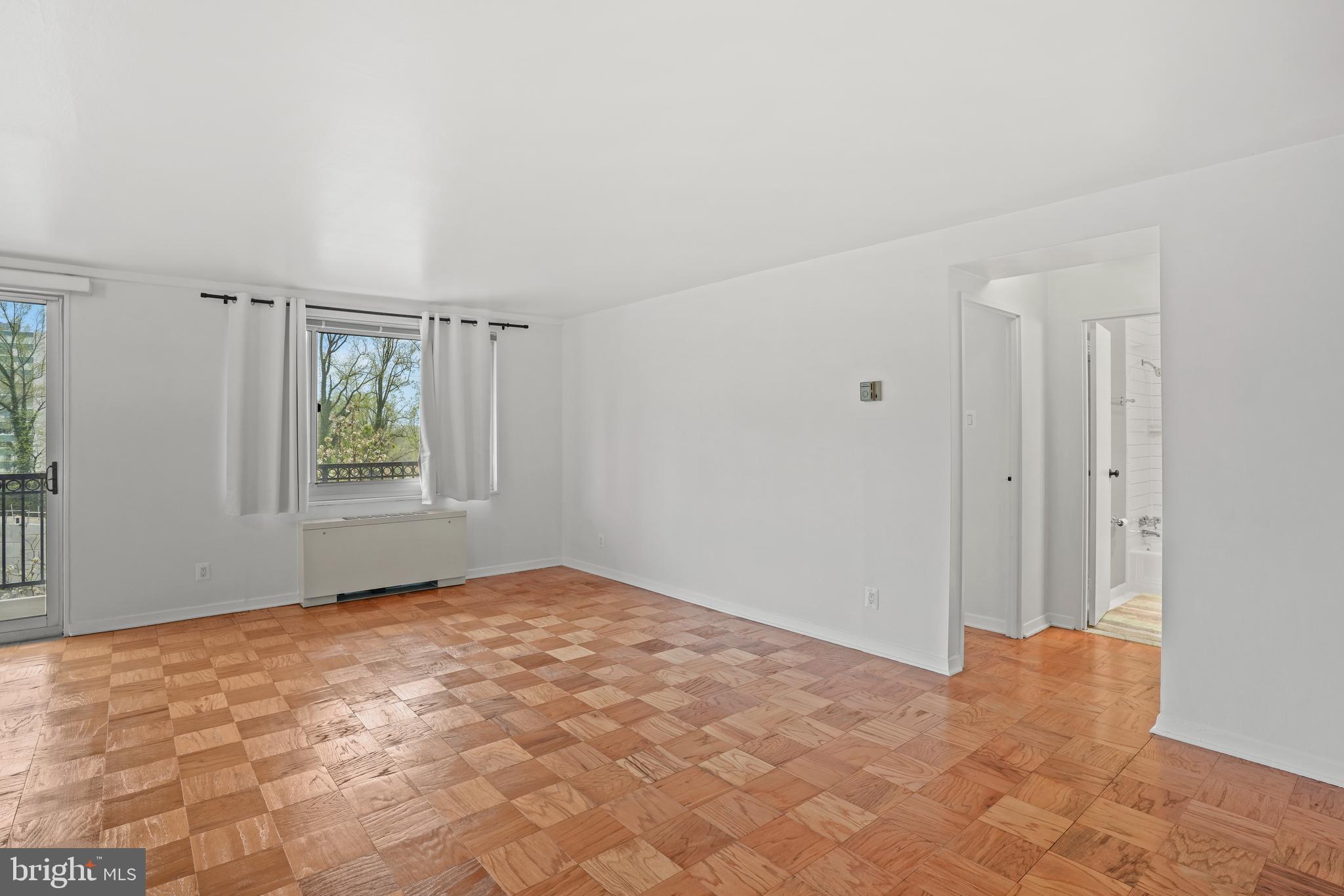 1900 Lyttonsville Road, Unit 612 Silver Spring, MD 20910 - Photo 6 of 23 a view of an empty room with windows