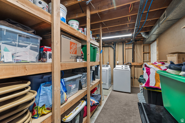 7659 State Street Midvale, UT 84047 - Photo 23 of 33 Basement area featuring a washer and dryer, exposed ceiling joists, wood stud walls, and overhead fluorescent lighting