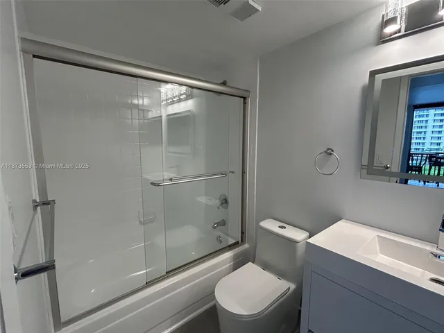 a bathroom with a shower a toilet and a sink