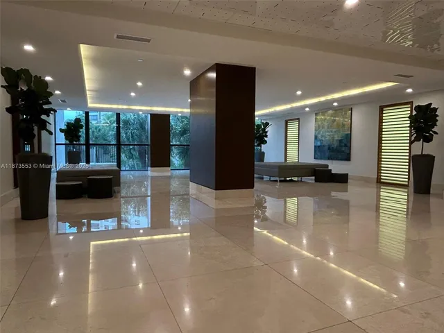 a lobby with furniture and a potted plant