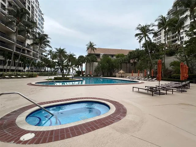 a view of swimming pool with outdoor seating and plants