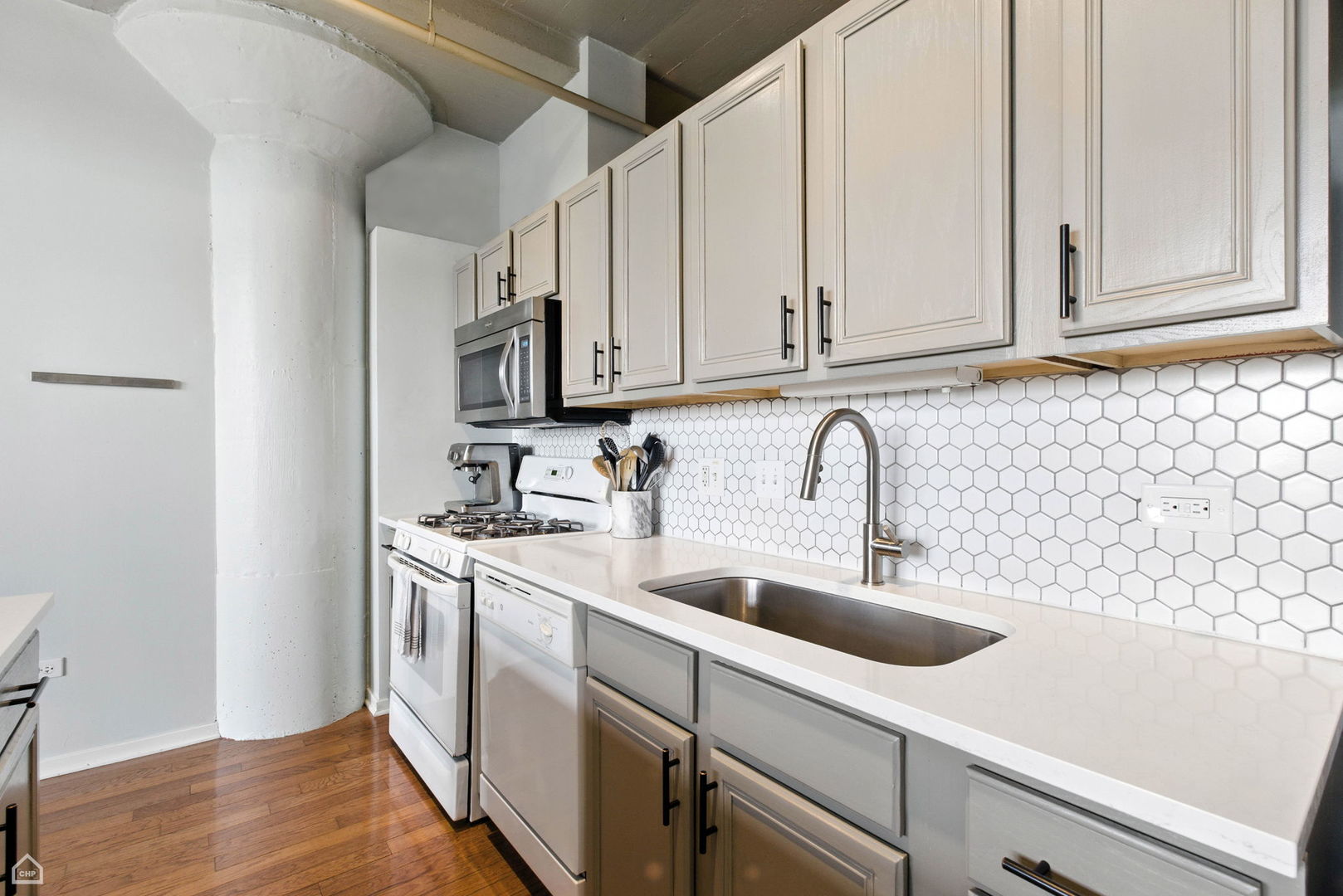 1524 South Sangamon Street, Unit 414S Chicago, IL 60608 - Photo 7 of 12 a view of a kitchen with sink and washing machine