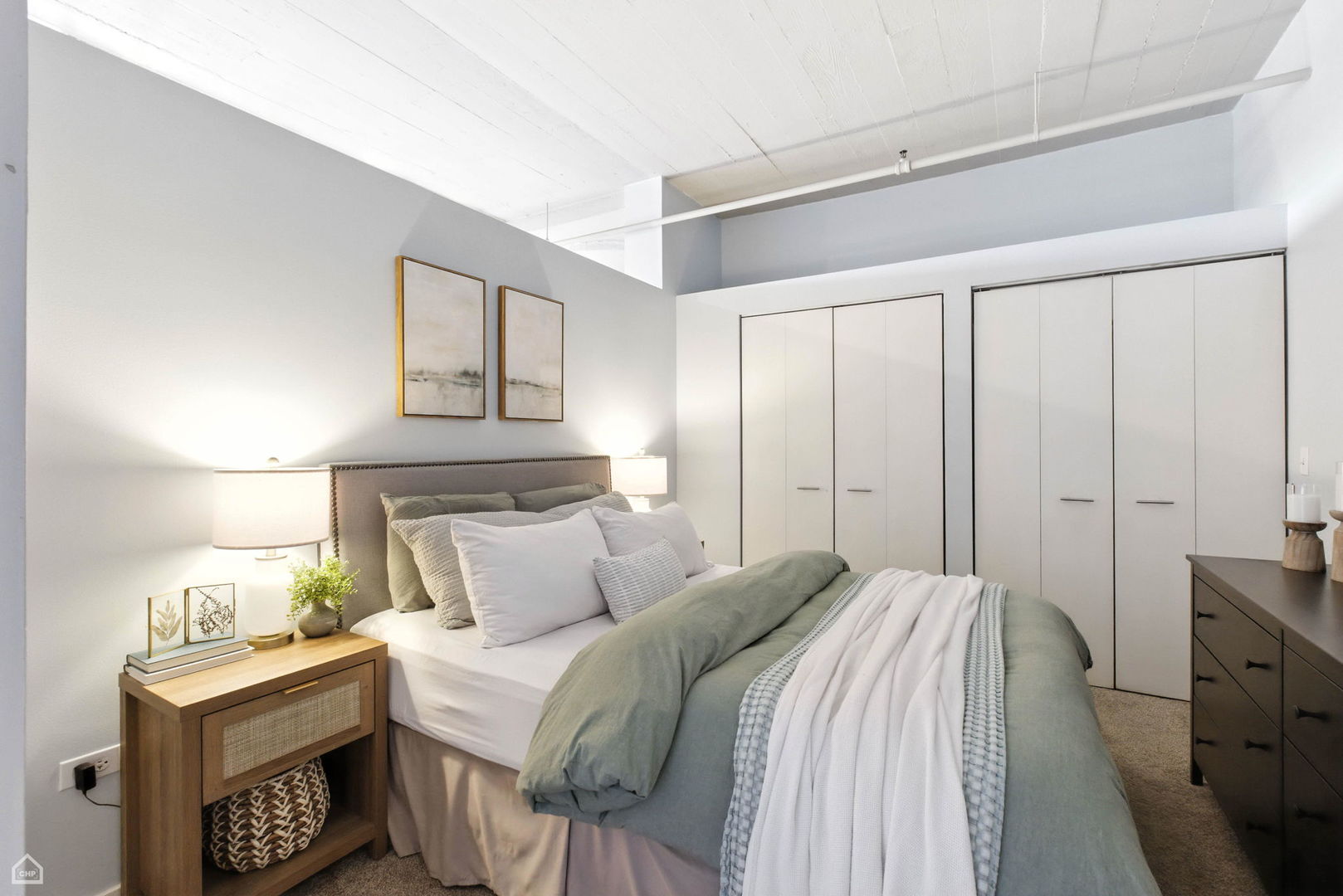 1524 South Sangamon Street, Unit 414S Chicago, IL 60608 - Photo 8 of 12 a bedroom with a bed and a night stand