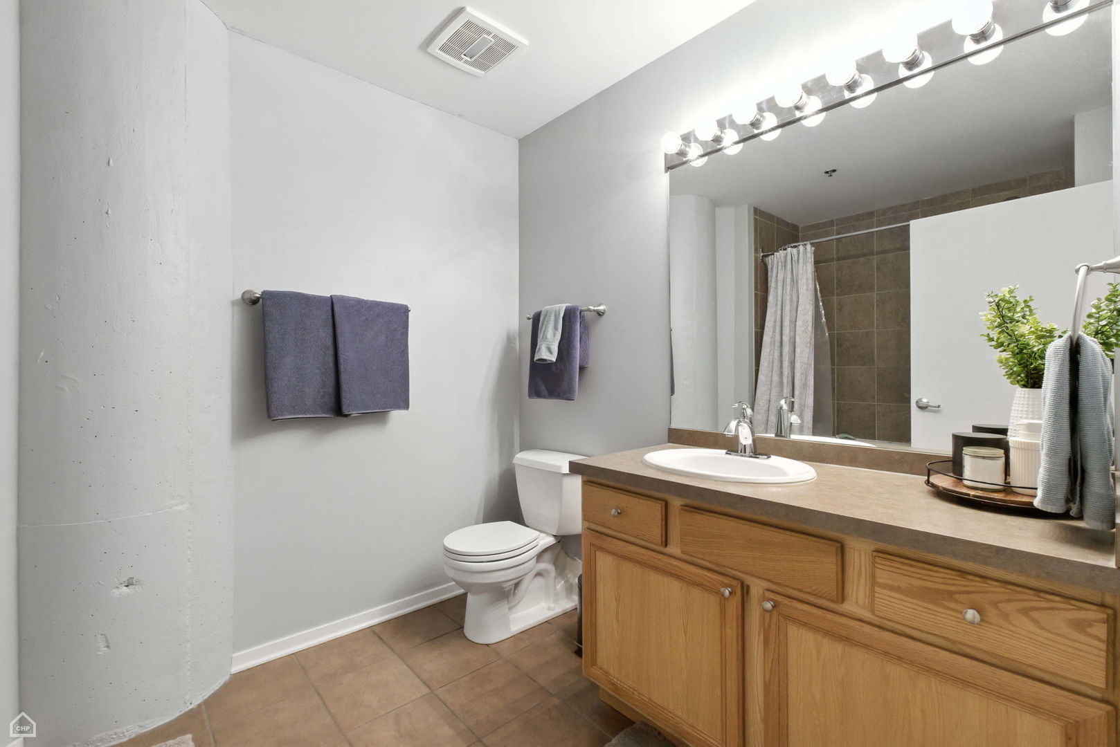 1524 South Sangamon Street, Unit 414S Chicago, IL 60608 - Photo 9 of 12 a bathroom with a toilet a sink and mirror