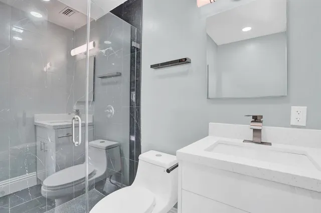a bathroom with a sink toilet and shower