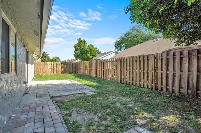 a view of a backyard with pathway